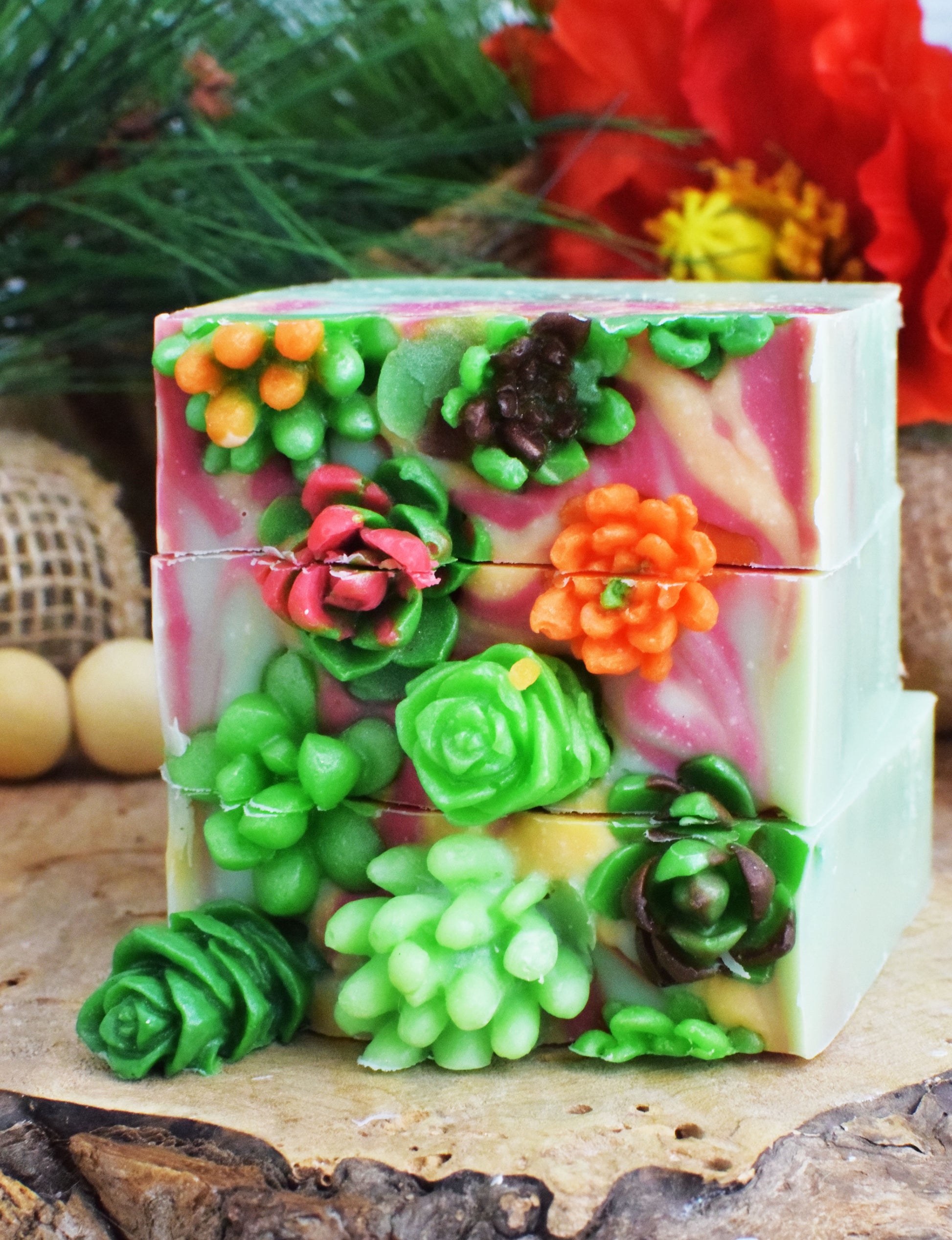 Decorative soap with green succulent-like designs on a natural surface