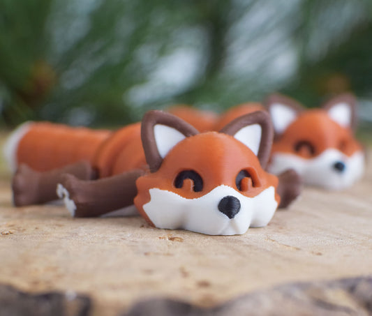 Red fox 3d figure on a wood surface with a green blurred background