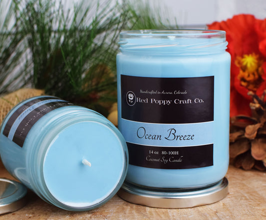 Blue candle with a label on a wooden surface with decorative elements